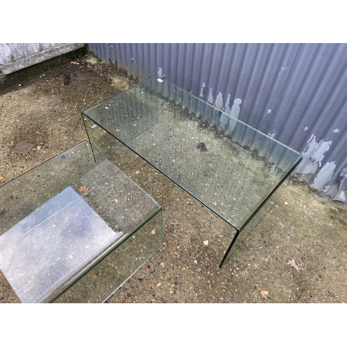 274 - A large and small pair of modern glass coffee tables larger 110x60x45