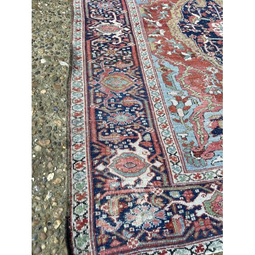 276 - An antique oriental red and blue Turkish pattern rug 150x170