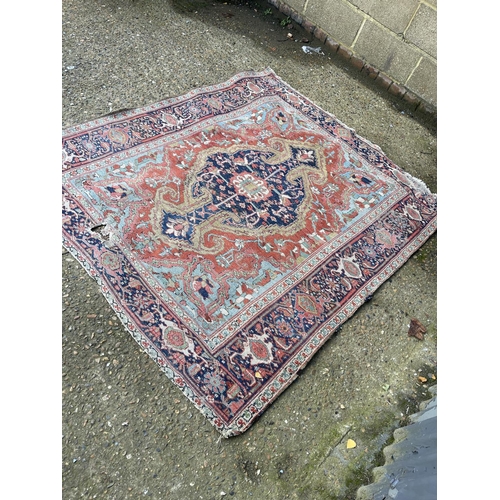 276 - An antique oriental red and blue Turkish pattern rug 150x170