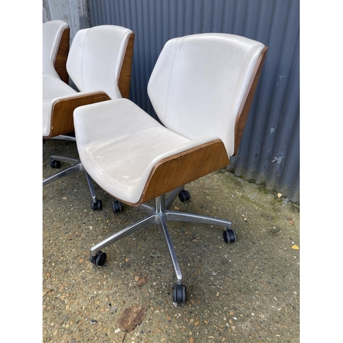 281 - Three EAMES STYLE cream upholstered swivel office chairs BY BOSS