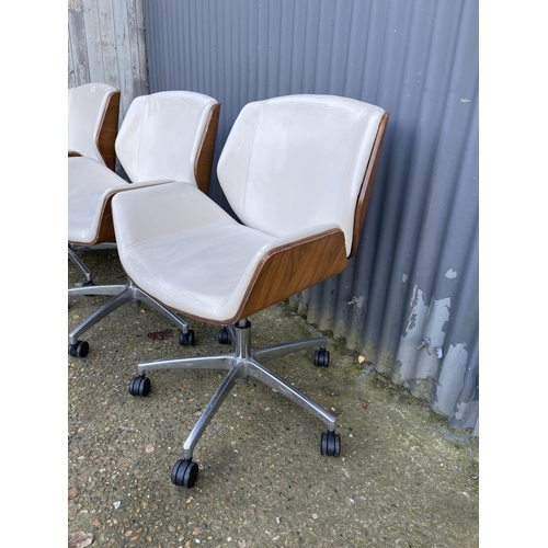 282 - Three EAMES STYLE cream upholstered swivel office chairs BY BOSS