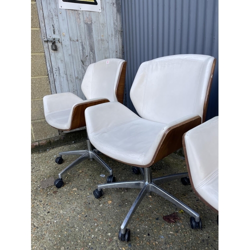 282 - Three EAMES STYLE cream upholstered swivel office chairs BY BOSS