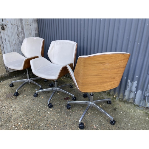 282 - Three EAMES STYLE cream upholstered swivel office chairs BY BOSS