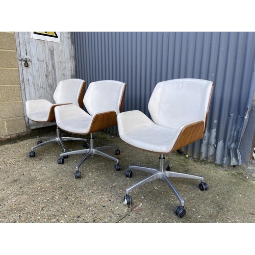 283 - Three EAMES STYLE cream upholstered swivel office chairs BY BOSS