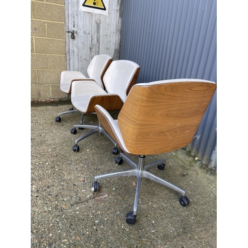 283 - Three EAMES STYLE cream upholstered swivel office chairs BY BOSS