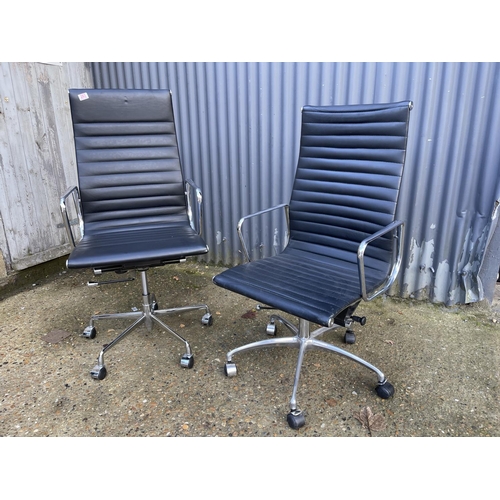 284 - A pair of EAMES style black leather and chome  swivel office chairs