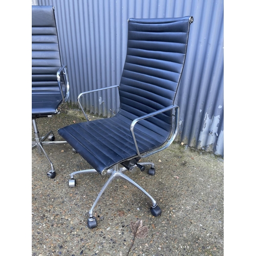 284 - A pair of EAMES style black leather and chome  swivel office chairs