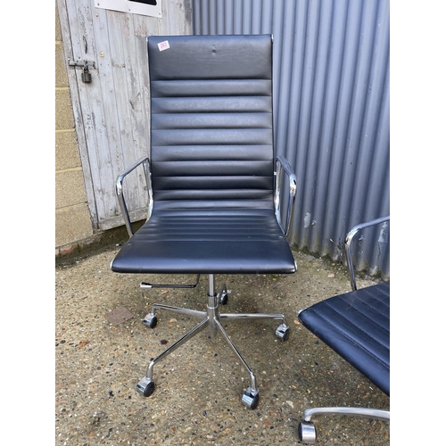 284 - A pair of EAMES style black leather and chome  swivel office chairs