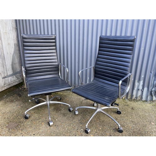 285 - A pair of EAMES style black leather and chome  swivel office chairs