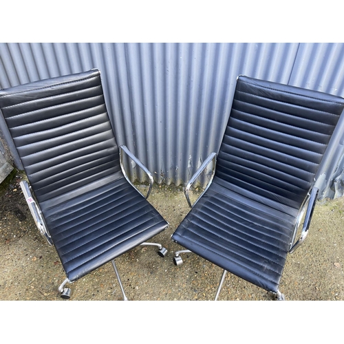 285 - A pair of EAMES style black leather and chome  swivel office chairs