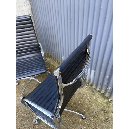 285 - A pair of EAMES style black leather and chome  swivel office chairs