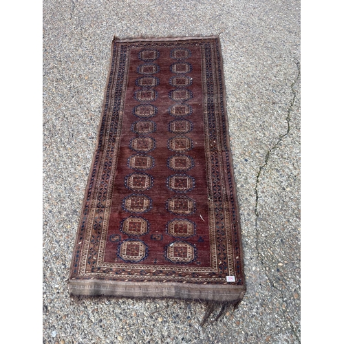 296 - A worn brown pattern rug