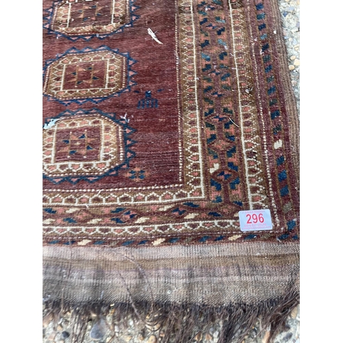 296 - A worn brown pattern rug