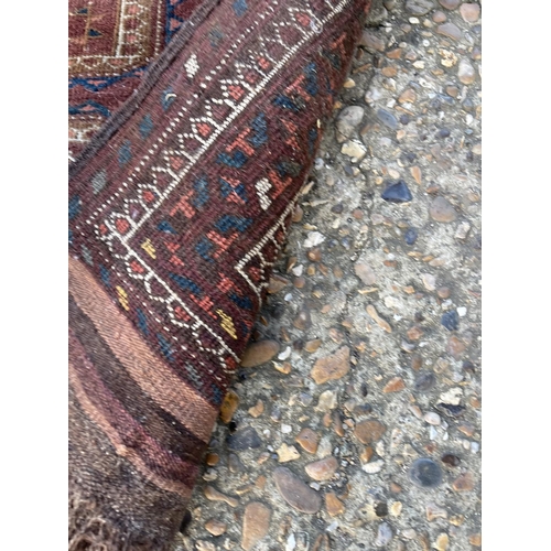 296 - A worn brown pattern rug