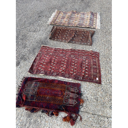 297 - Four small oriental rugs / mats