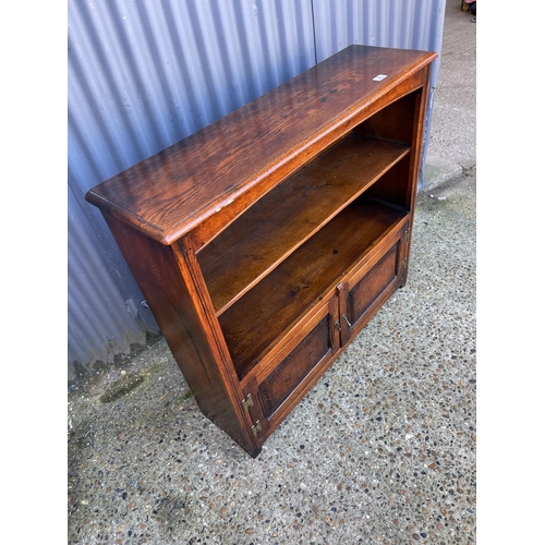 30 - A reproduction oak bookcase by TENTERDEN HOUSE INTERIORS 108cm wide