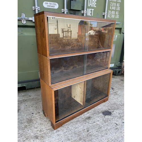 347 - Glazed oak three section bookcase with sliding doors