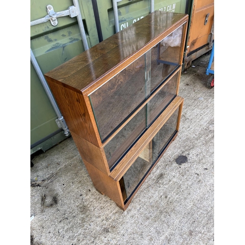 347 - Glazed oak three section bookcase with sliding doors