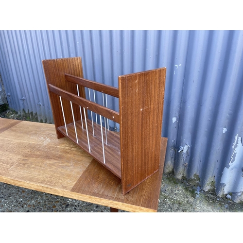 37 - A mid century teak coffee table  together with a teak magazine rack