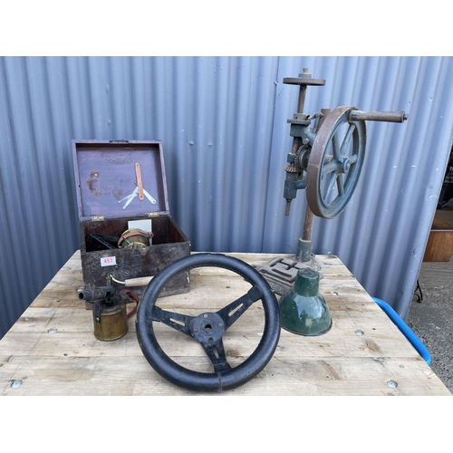 453 - Two brass blow torches, steering wheel, enamel shade and a vintage drill press