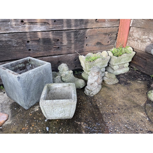 479 - A collection of concrete planters and ornaments