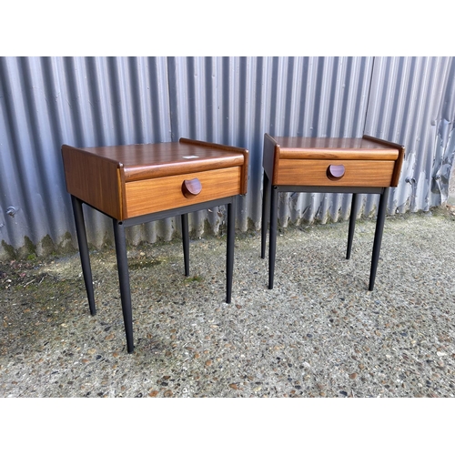 54 - A pair of mid century teak single drawer side tables raised on MAT black tapering legs