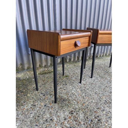 54 - A pair of mid century teak single drawer side tables raised on MAT black tapering legs