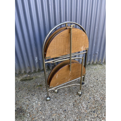 55 - A mid century brass and teak folding trolley cake stand