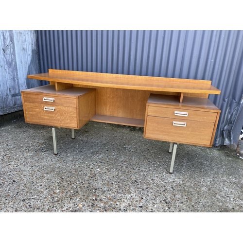 56 - A mid century stag four drawer kneehole desk