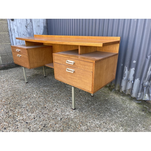 56 - A mid century stag four drawer kneehole desk