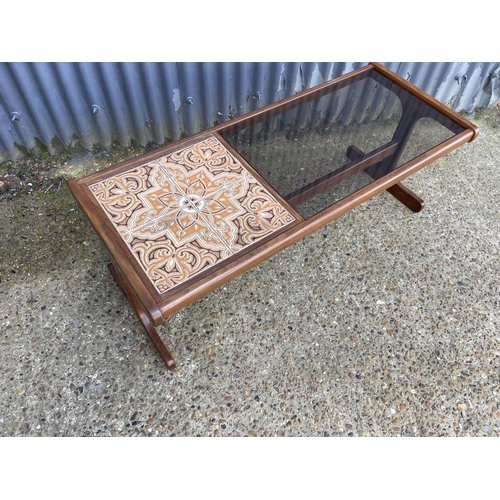 58 - A g plan teak coffee table with a tiled top and drop in glass surface