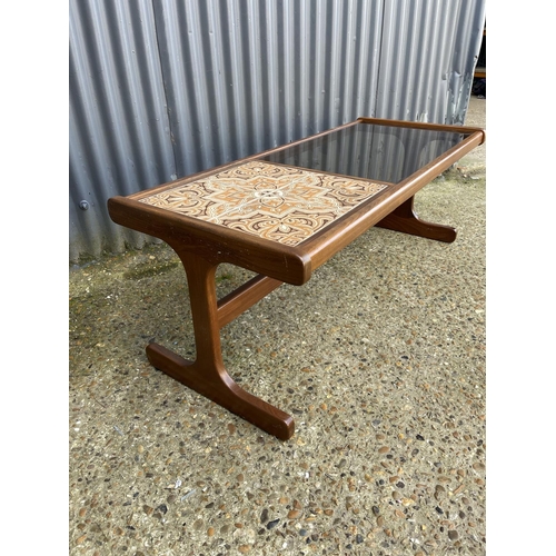 58 - A g plan teak coffee table with a tiled top and drop in glass surface