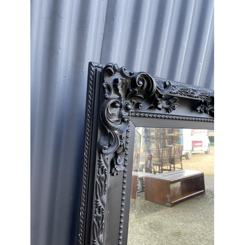 62 - A very large ornate black framed mirror