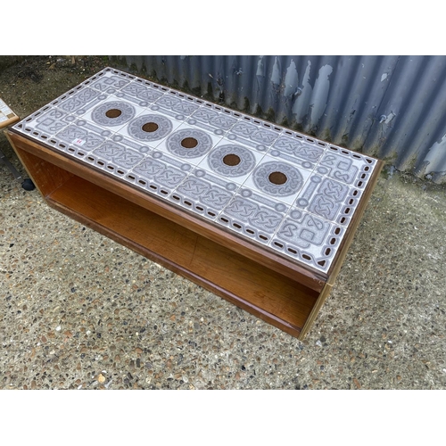 64 - A rectangular teak tile top coffee table together with a tile top trolley