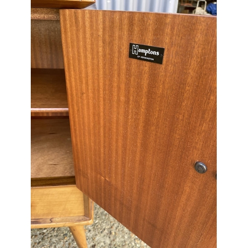 66 - A mid century four door and two drawer sideboard in French walnut by YOUNGER retailed and labelled H... 