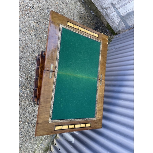 72 - An Edwardian inlaid fold over games table with drawer