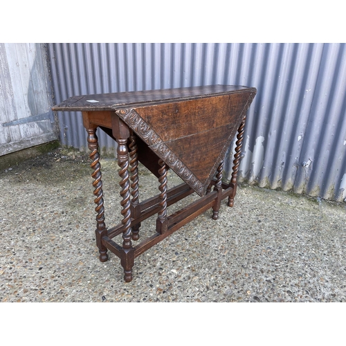 74 - A carved oak gateleg table