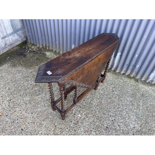 74 - A carved oak gateleg table