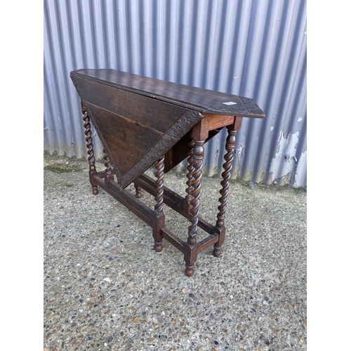 74 - A carved oak gateleg table