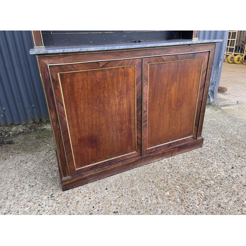 84 - A french empire mahogany bookcase cupboard  with  brass beading and a grey marble surface 126x45 x23... 