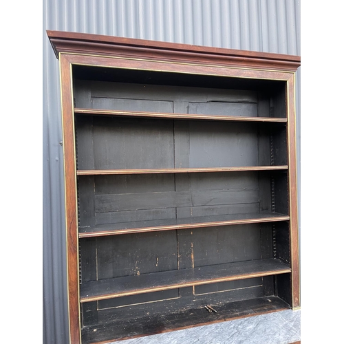 84 - A french empire mahogany bookcase cupboard  with  brass beading and a grey marble surface 126x45 x23... 