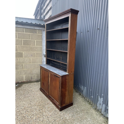 84 - A french empire mahogany bookcase cupboard  with  brass beading and a grey marble surface 126x45 x23... 