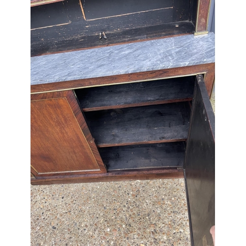 84 - A french empire mahogany bookcase cupboard  with  brass beading and a grey marble surface 126x45 x23... 