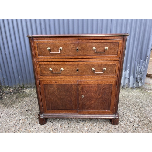 85 - A french empire mahogany two drawer bachelors  cupboard  95x 46 x100