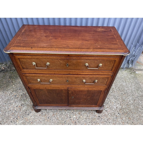 85 - A french empire mahogany two drawer bachelors  cupboard  95x 46 x100