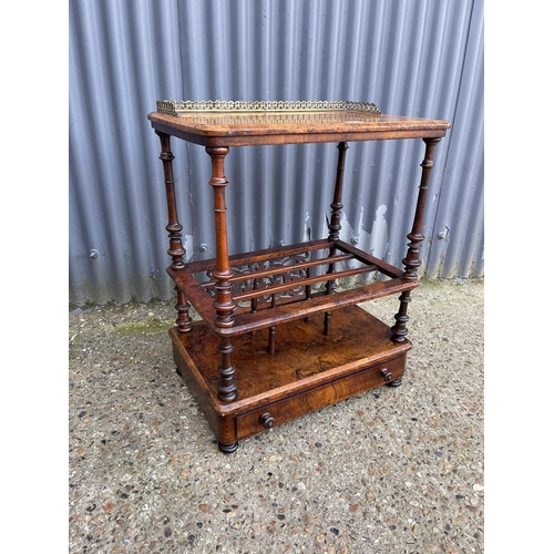 87 - A Victorian walnut inlaid canterbury with a brass gallery back and single drawer