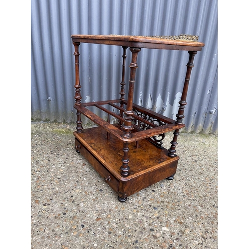 87 - A Victorian walnut inlaid canterbury with a brass gallery back and single drawer