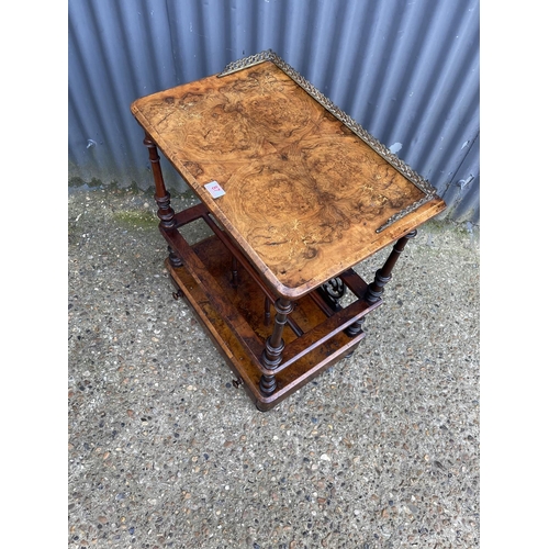 87 - A Victorian walnut inlaid canterbury with a brass gallery back and single drawer