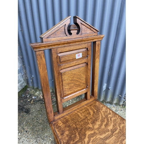 88 - An oak panel back hall chair