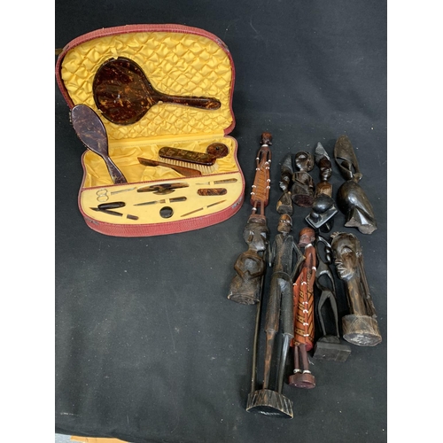 1057 - Collection of ethnic carved figures and cased faux tortoiseshell manicure set